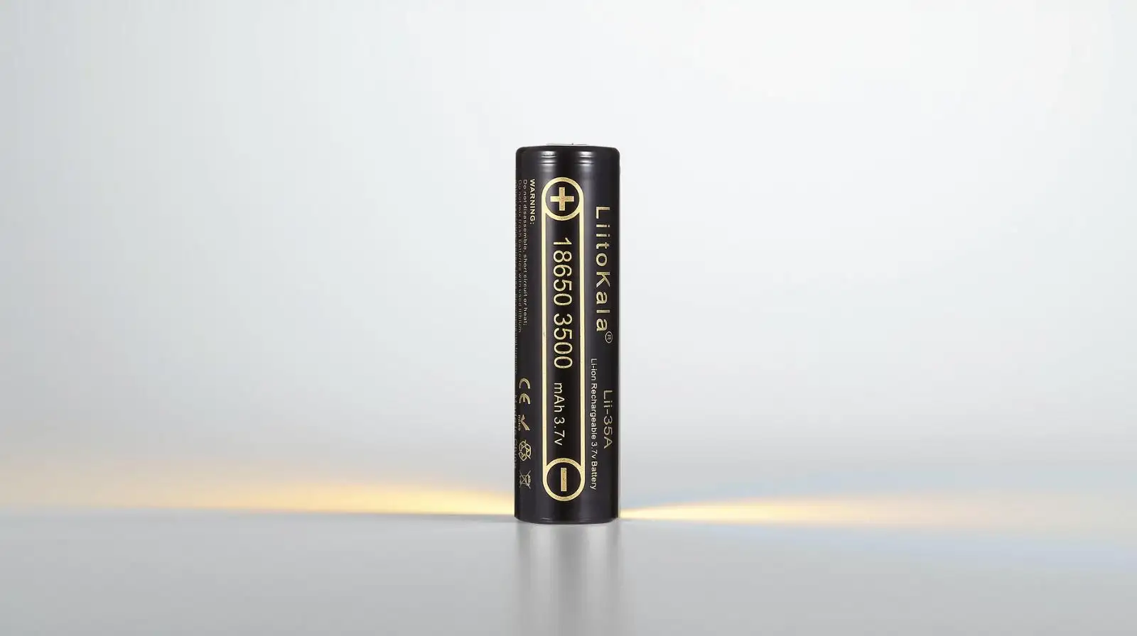 Professional studio photo of an 18650 lithium-ion battery standing upright on a white background.